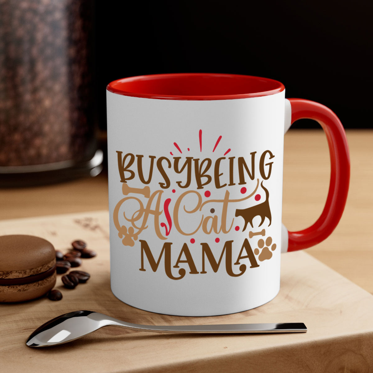 A stylish two-tone ceramic mug with a colored handle and interior, featuring the phrase 'Busy Being A Cat Mama' in a glossy finish.