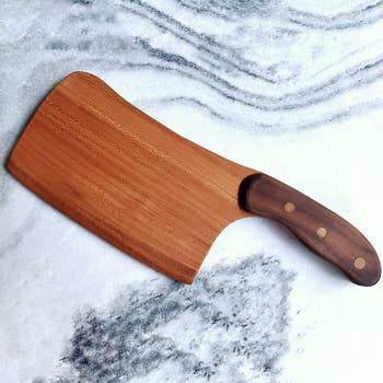 A wooden cabbage cleaver with a wide blade, ideal for chopping greens without browning.