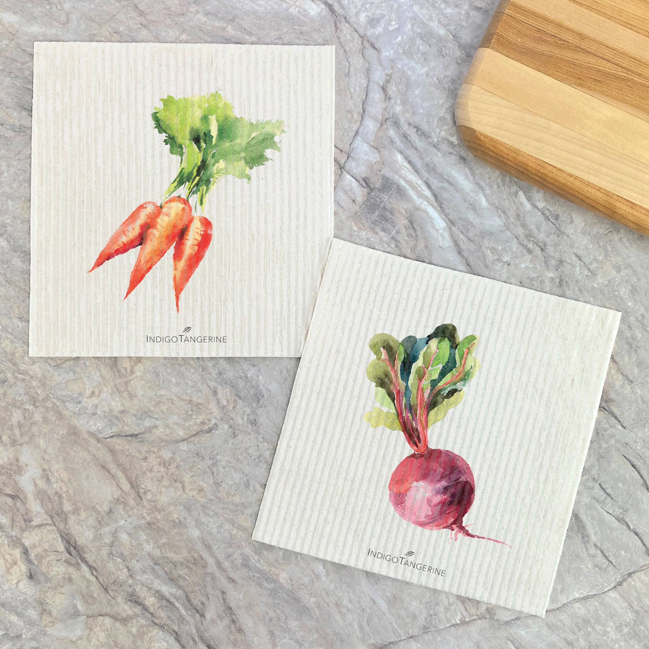 Two Swedish dish cloths featuring carrot and beet designs, made from eco-friendly materials.