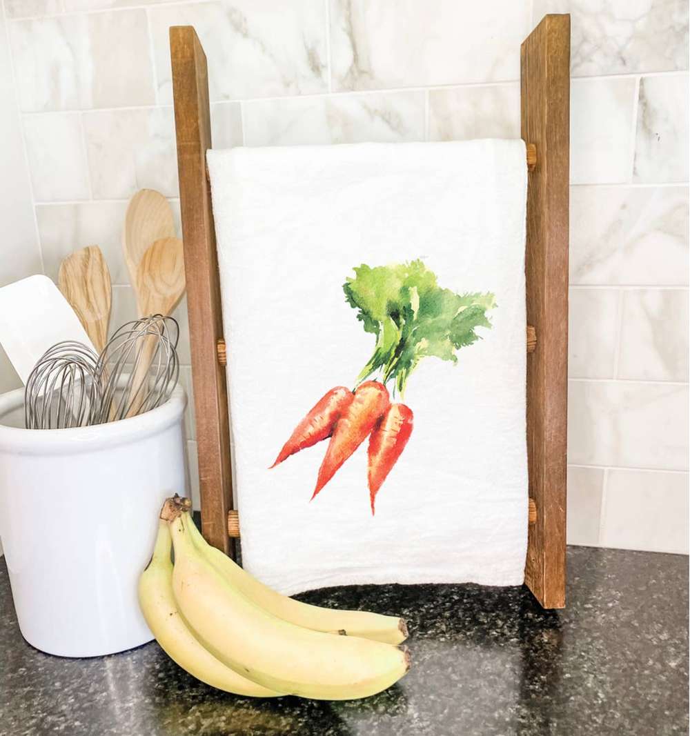 A vibrant cotton tea towel featuring a beautiful carrot design, perfect for kitchen use.