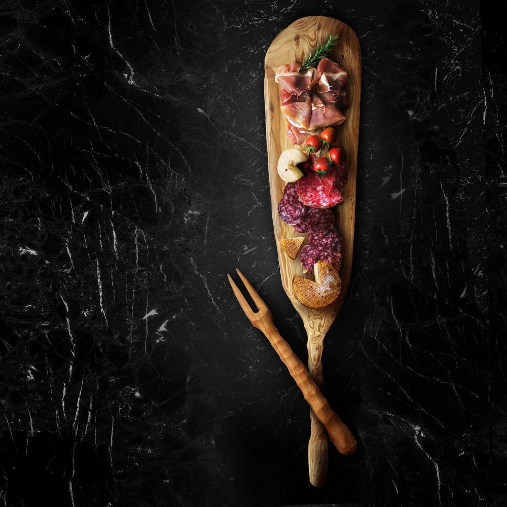 A beautifully crafted Charcuterie Paddle Board showcasing an array of meats, cheeses, and fruits, perfect for entertaining.