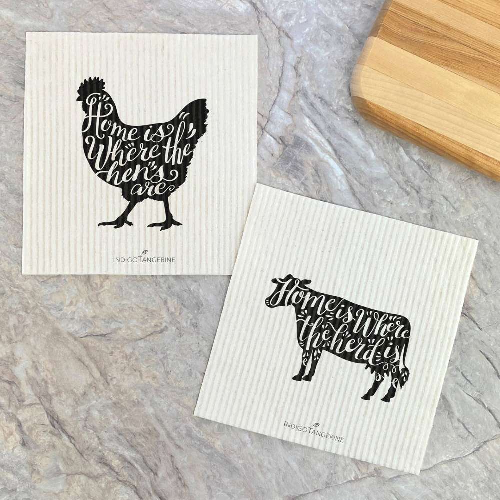 Two Swedish dish cloths featuring chicken and cow designs, made from eco-friendly materials.