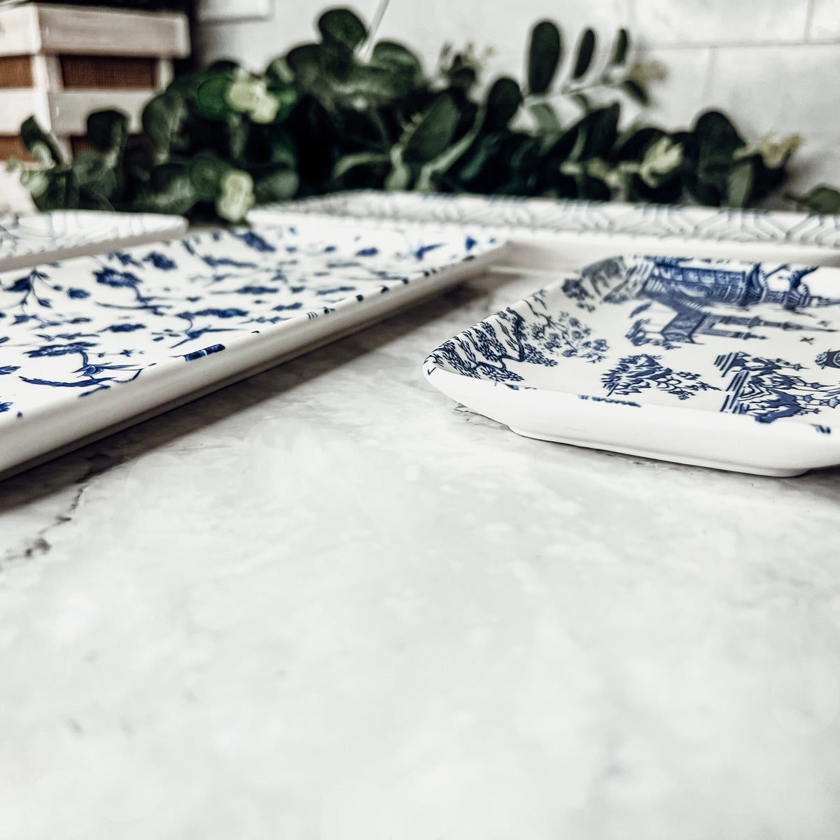 Chinoiserie Serving Set featuring 4 pieces with blue and white patterns, including serving and tidbit trays.