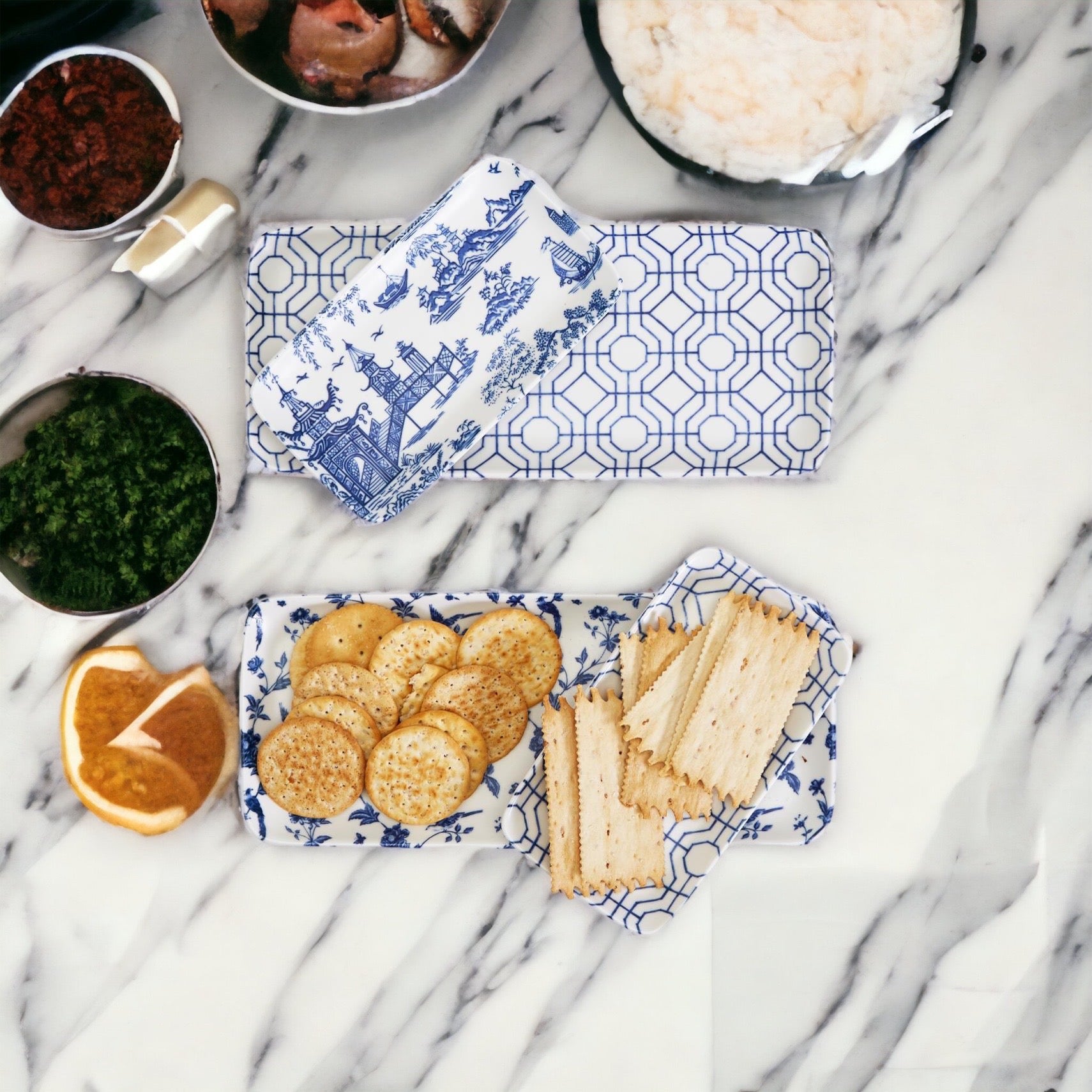 Chinoiserie Serving Set featuring 4 pieces with blue and white patterns, including serving and tidbit trays.