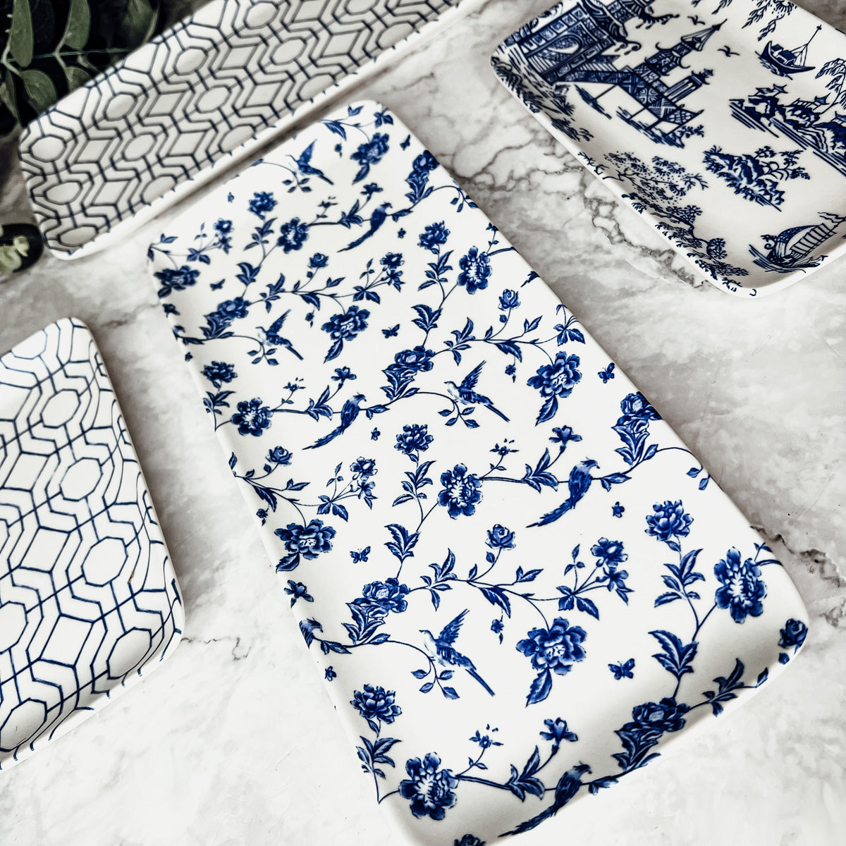 Chinoiserie Serving Set featuring 4 pieces with blue and white patterns, including serving and tidbit trays.