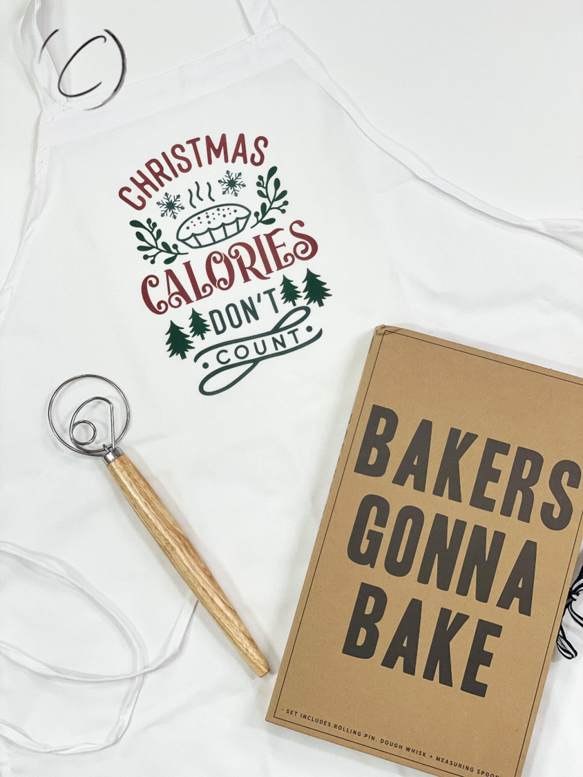 Christmas Calories Don't Count Apron featuring a humorous design, made from soft brushed filament polyester with long waist ties.