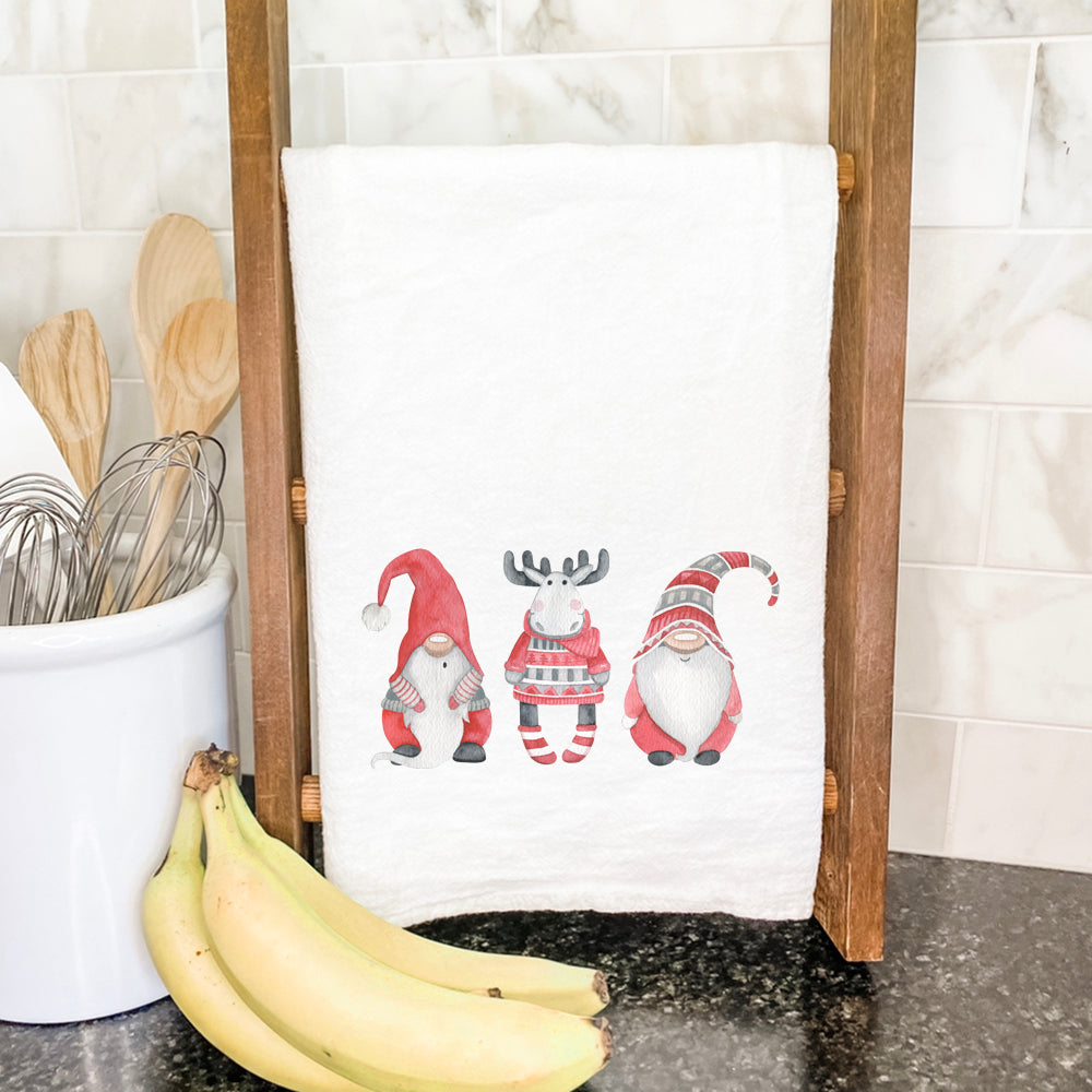 A festive cotton tea towel featuring whimsical Christmas gnomes and a moose design, perfect for holiday kitchens.