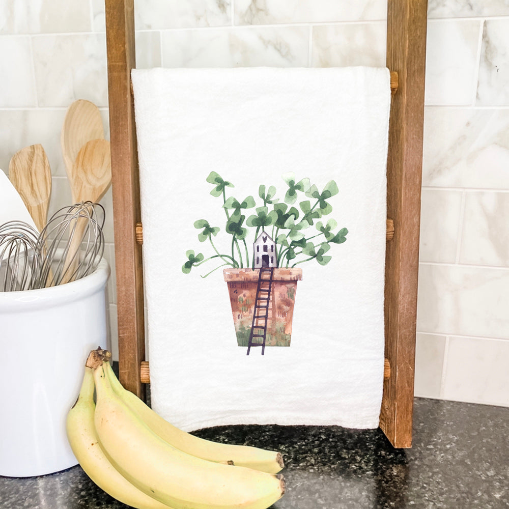 Clover Fairy House cotton tea towel featuring a whimsical design, vibrant colors, and hemmed edges, perfect for kitchen use.