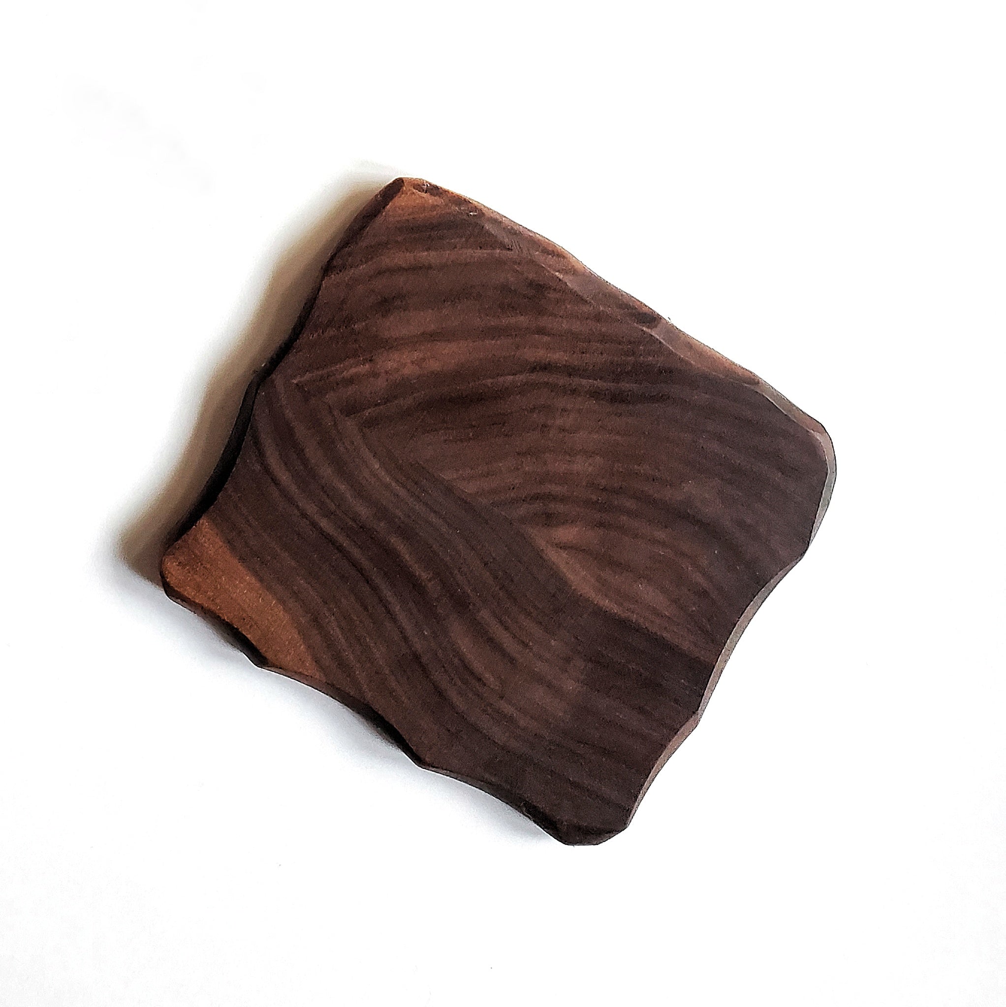 Set of four 4x4 coasters with chiseled edges in black walnut, cherry, and maple finishes, showcasing their elegant design.