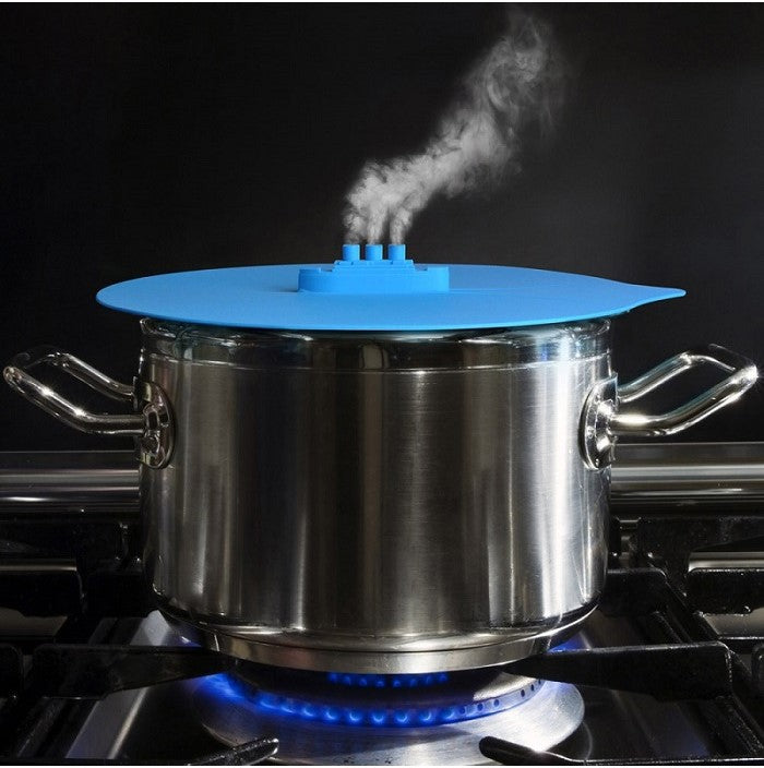 Colorful silicone cooking lid shaped like a ship, designed for kitchen use, featuring three sizes and ear hook for space-saving.