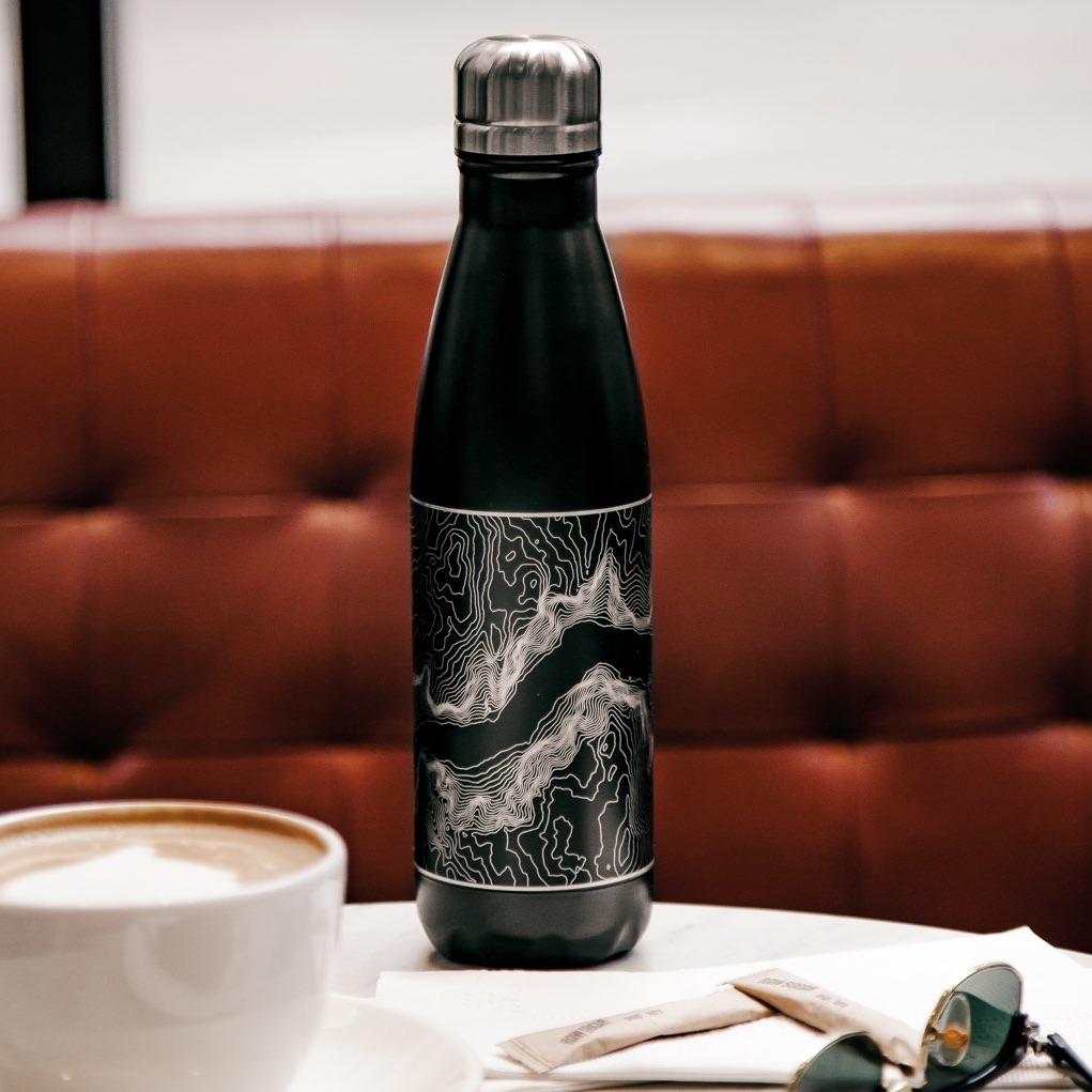 Matte black insulated bottle featuring a custom engraved map of Crater Lake National Park, Oregon.