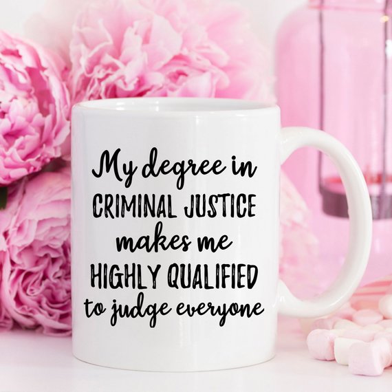 A stylish white ceramic mug featuring a vibrant criminal justice design, suitable for coffee or tea.