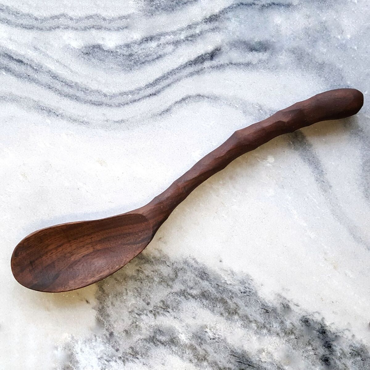 Curvy Ergonomic Cooking Spoon in Cherry and Walnut finishes, showcasing its comfortable grip and stylish design.