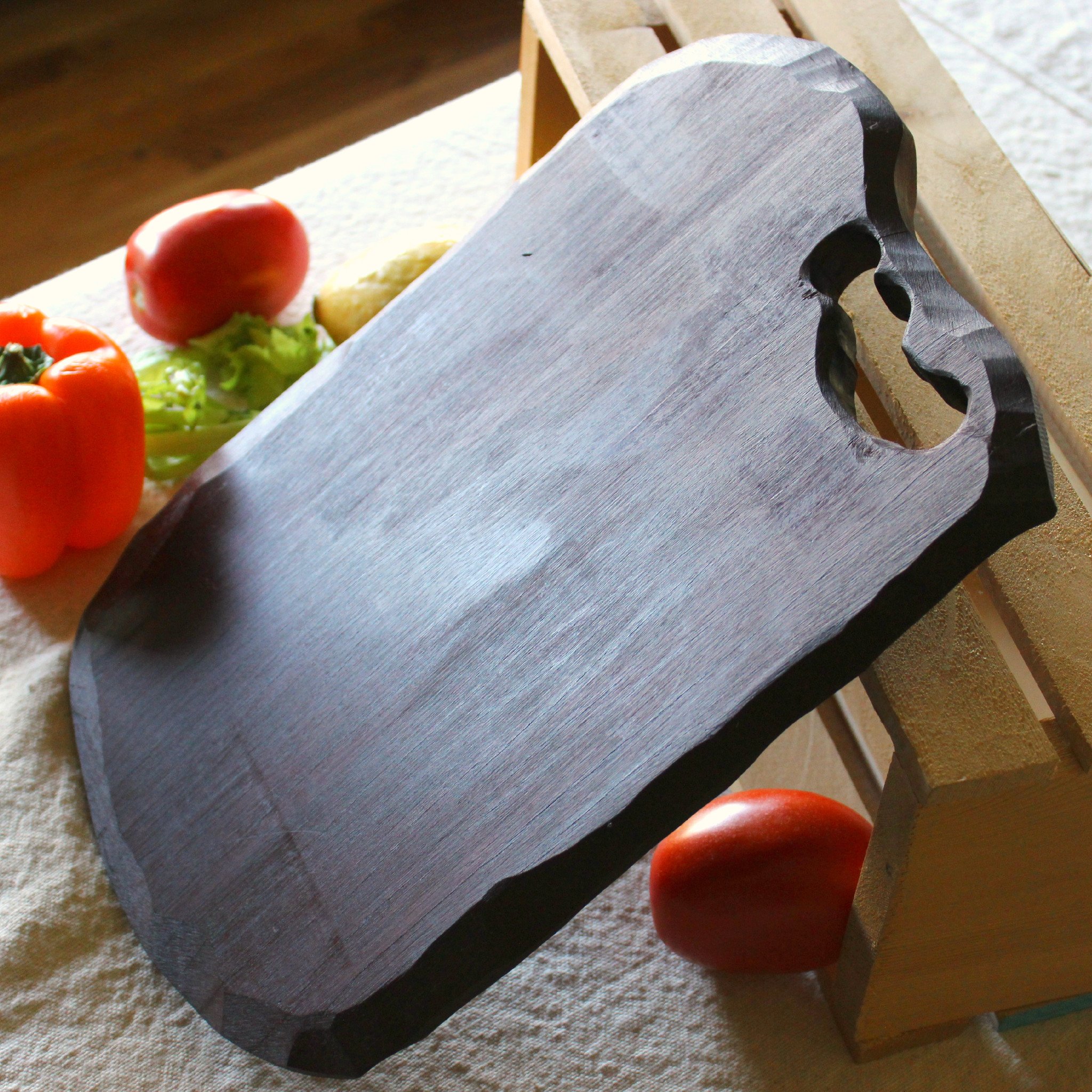 Stylish wooden cutting board measuring 13" x 8" with hand chiseled edge and olive oil finish.