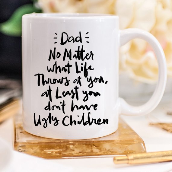 Funny coffee mug for dads with humorous text about parenting, made of high-quality ceramic.