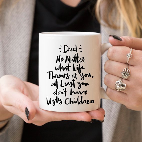 Funny coffee mug for dads with humorous text about parenting, made of high-quality ceramic.