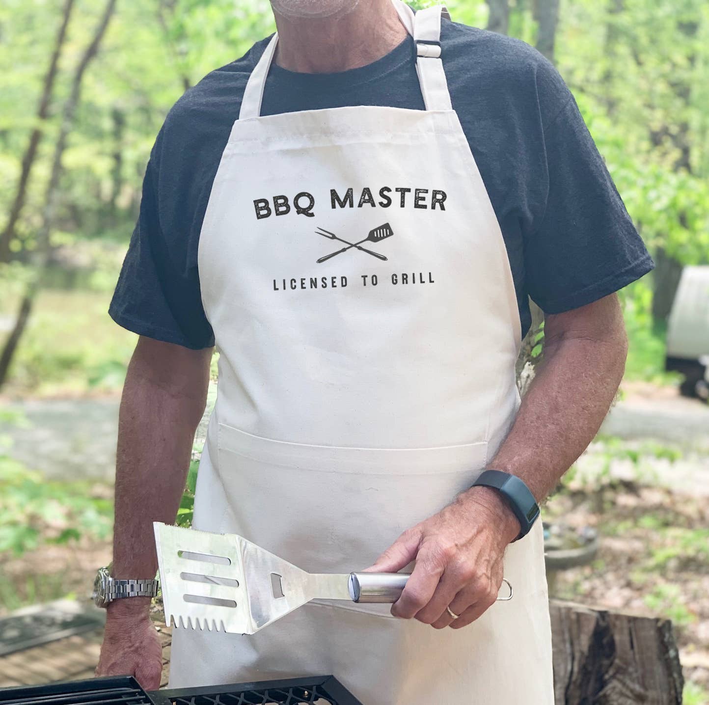 Dad's BBQ Master Licensed to Grill apron made of durable cotton canvas with adjustable neck and twill ties, featuring a vibrant printed design.