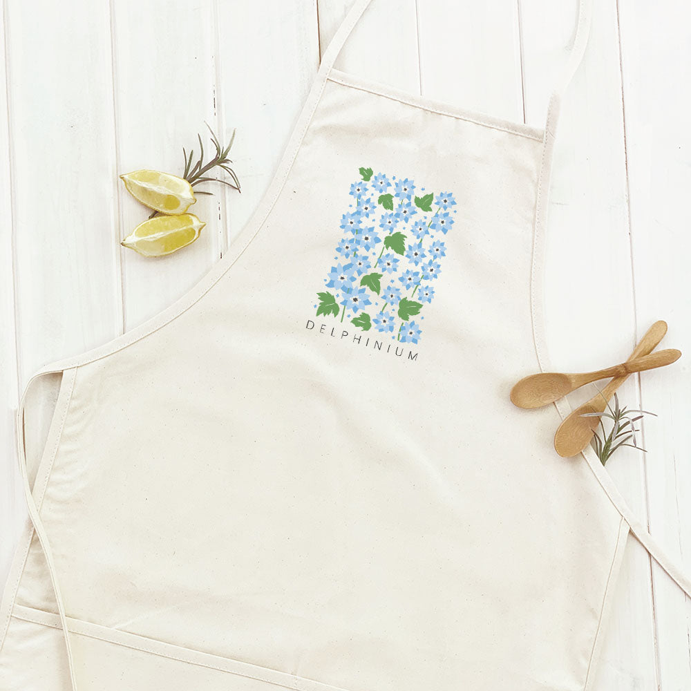 Delphinium Women's Apron featuring elegant design, cotton canvas fabric, and divided front pocket, perfect for cooking and gardening.