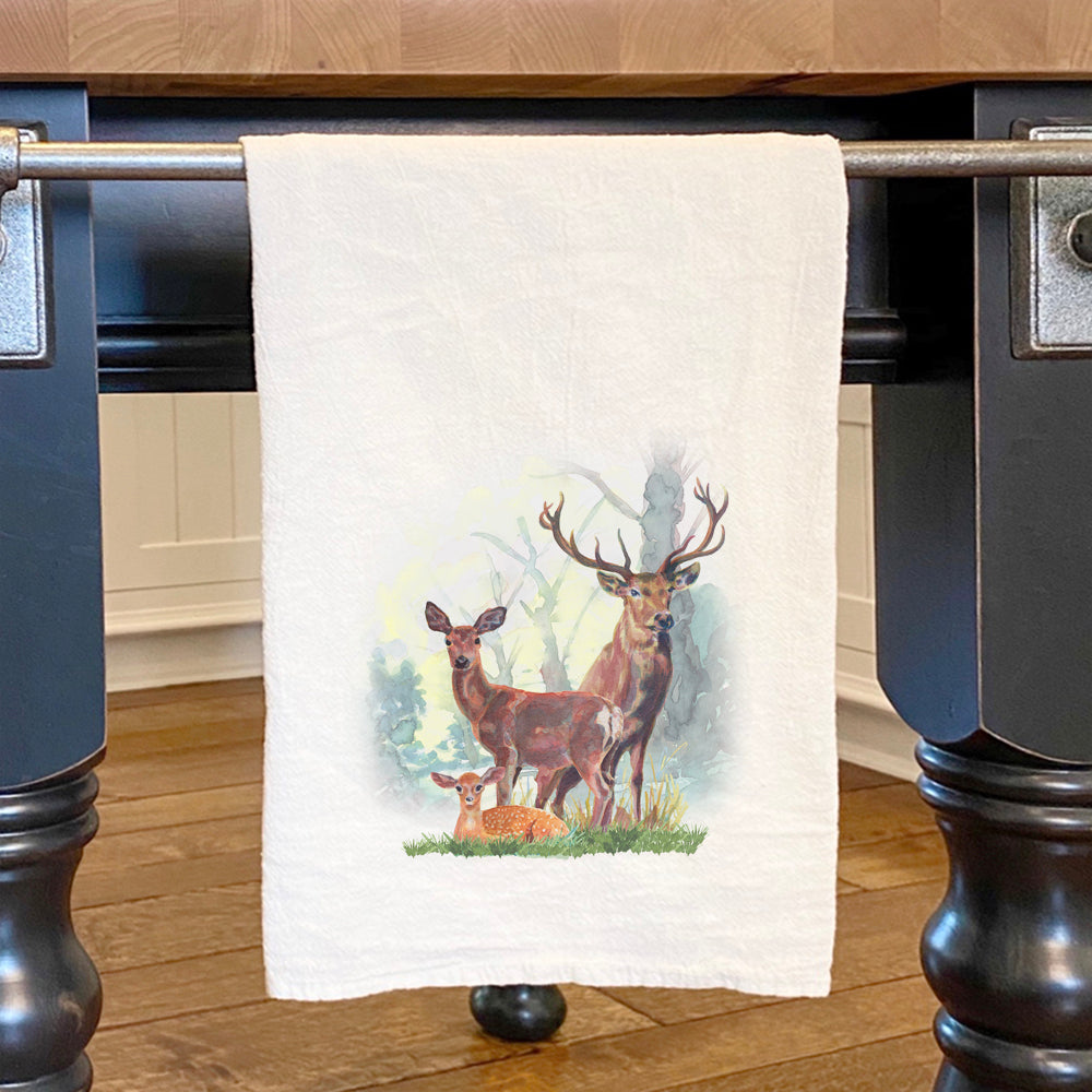 A beautifully designed cotton tea towel featuring a deer family in a forest setting, showcasing vibrant colors and intricate details.