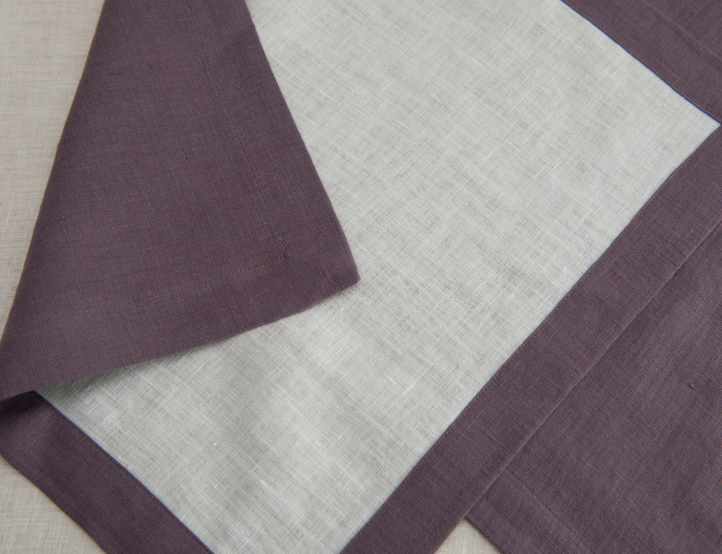 Set of double-sided linen napkins in various colors, showcasing their unique design and soft texture.