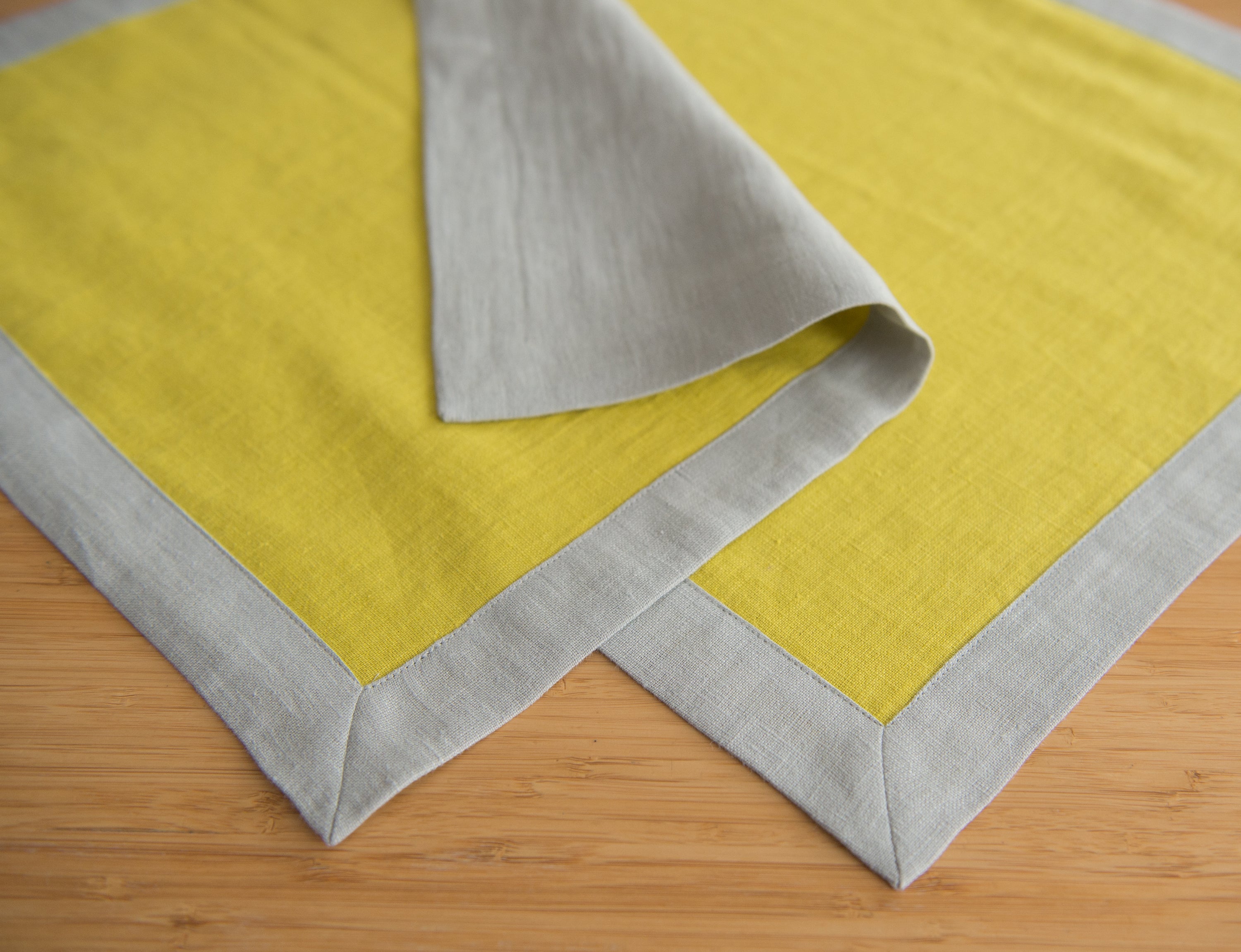 Set of double-sided linen napkins in various colors, showcasing their unique design and soft texture.