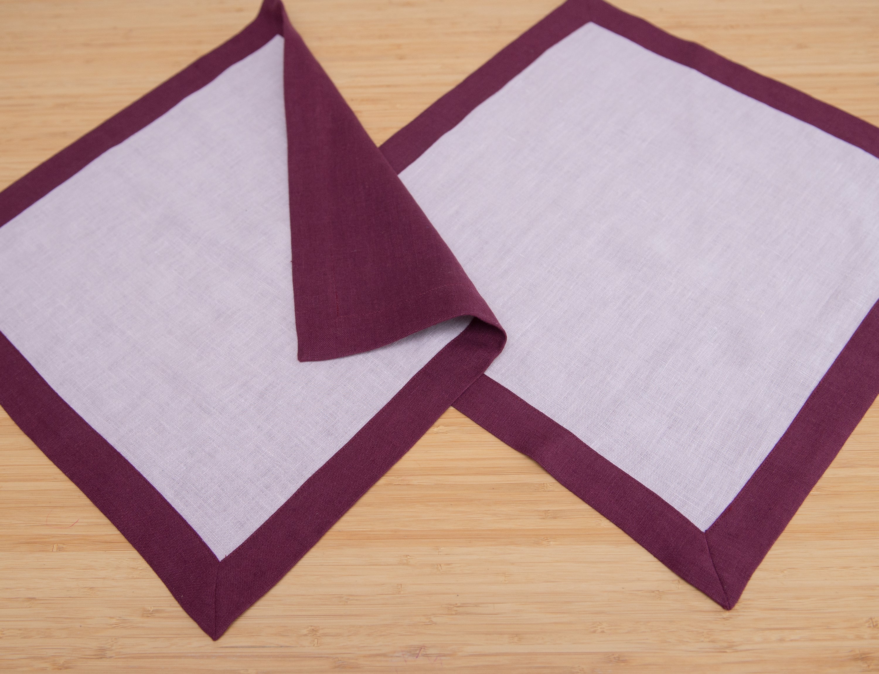 Set of double-sided linen napkins in various colors, showcasing their unique design and soft texture.