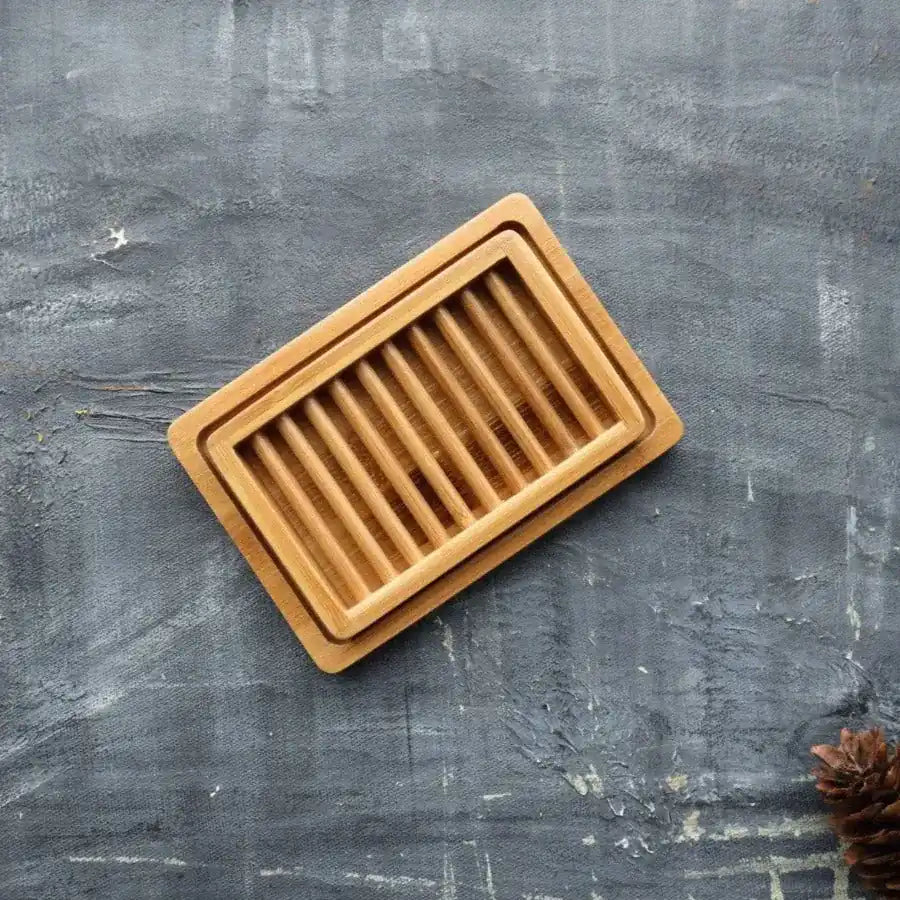 A stylish dual-layer bamboo soap dish with a drying rack and draining tray, designed for eco-friendly living.