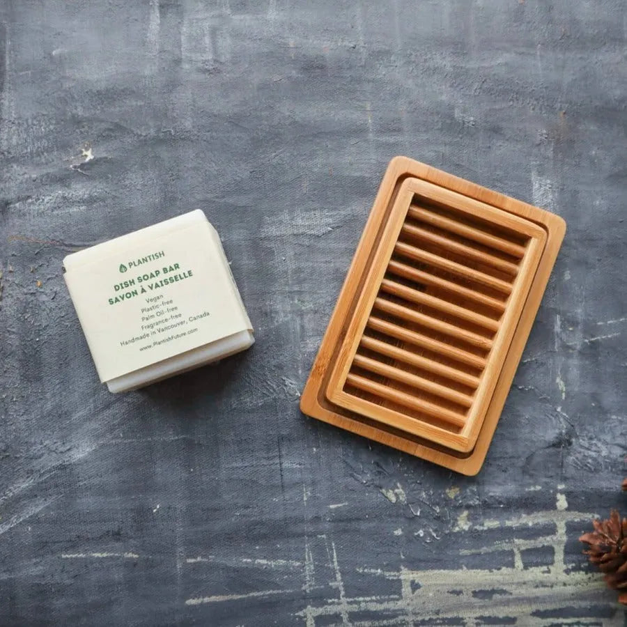 A stylish dual-layer bamboo soap dish with a drying rack and draining tray, designed for eco-friendly living.