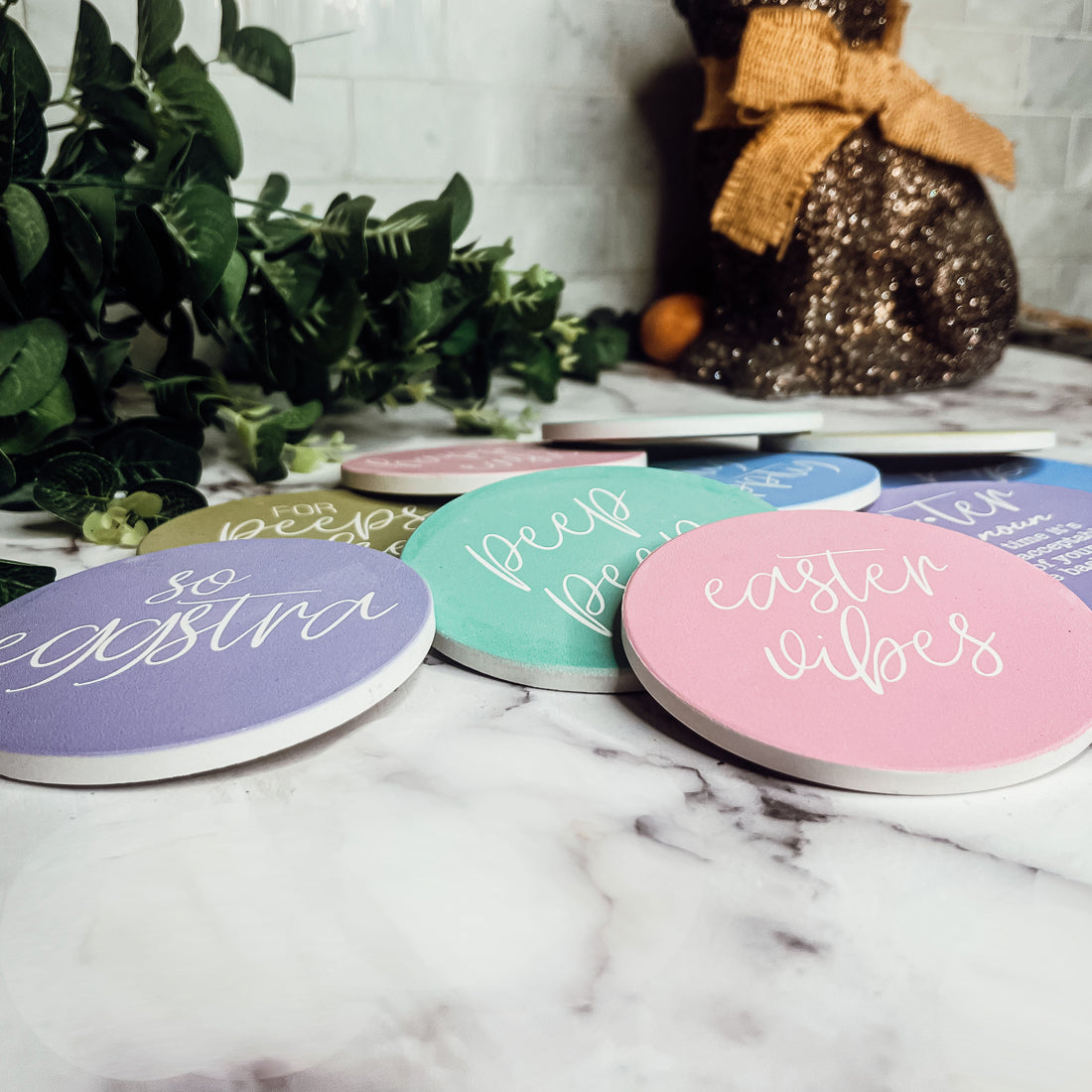 A set of colorful ceramic coasters featuring Easter and spring designs, showcasing a matte finish and cork backing for protection.