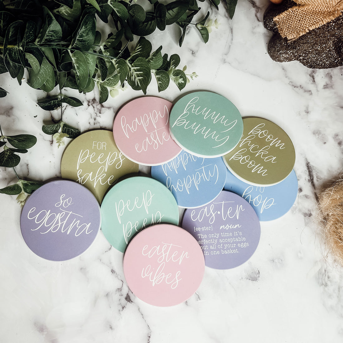 A set of colorful ceramic coasters featuring Easter and spring designs, showcasing a matte finish and cork backing for protection.