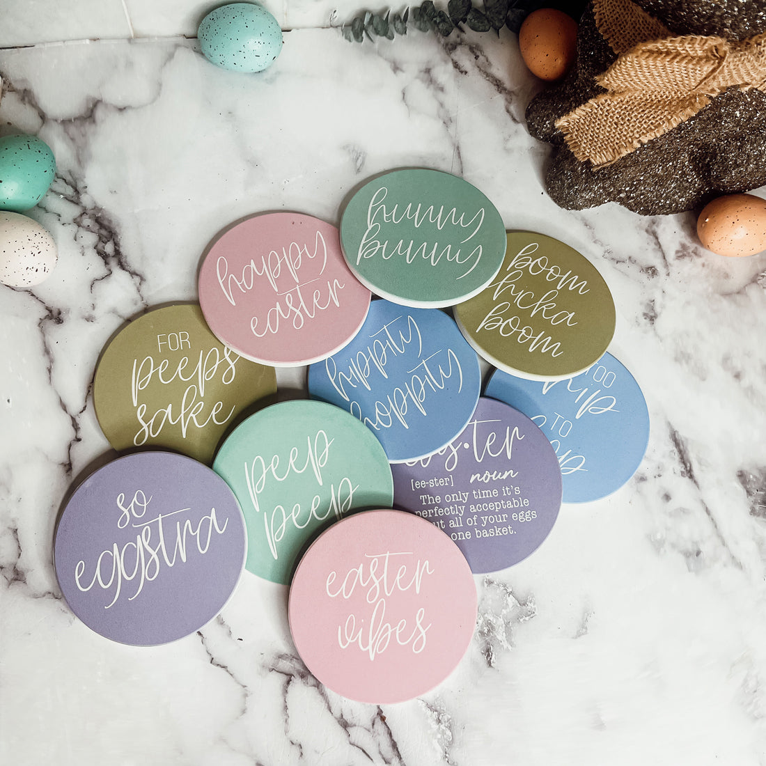 A set of colorful ceramic coasters featuring Easter and spring designs, showcasing a matte finish and cork backing for protection.