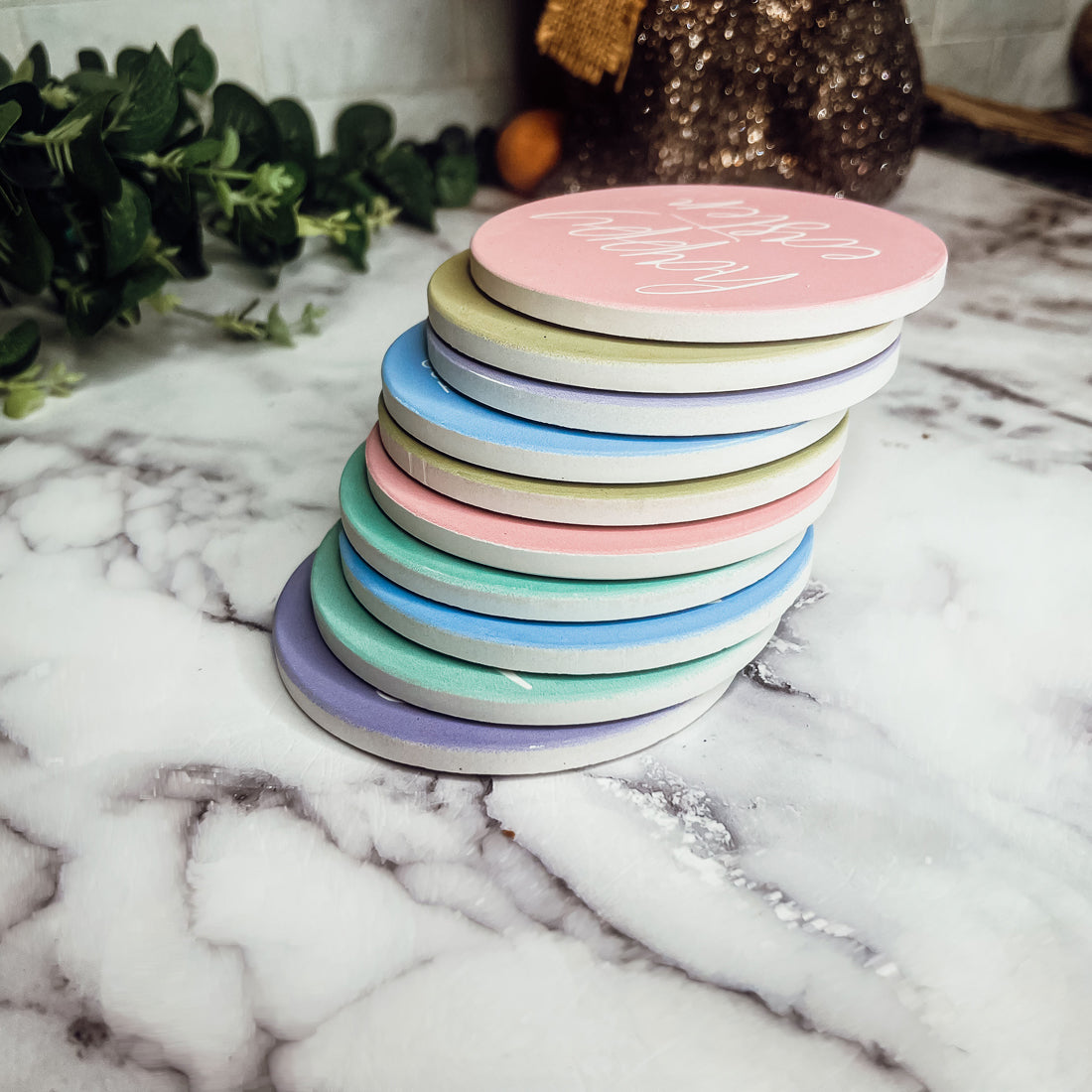 A set of colorful ceramic coasters featuring Easter and spring designs, showcasing a matte finish and cork backing for protection.