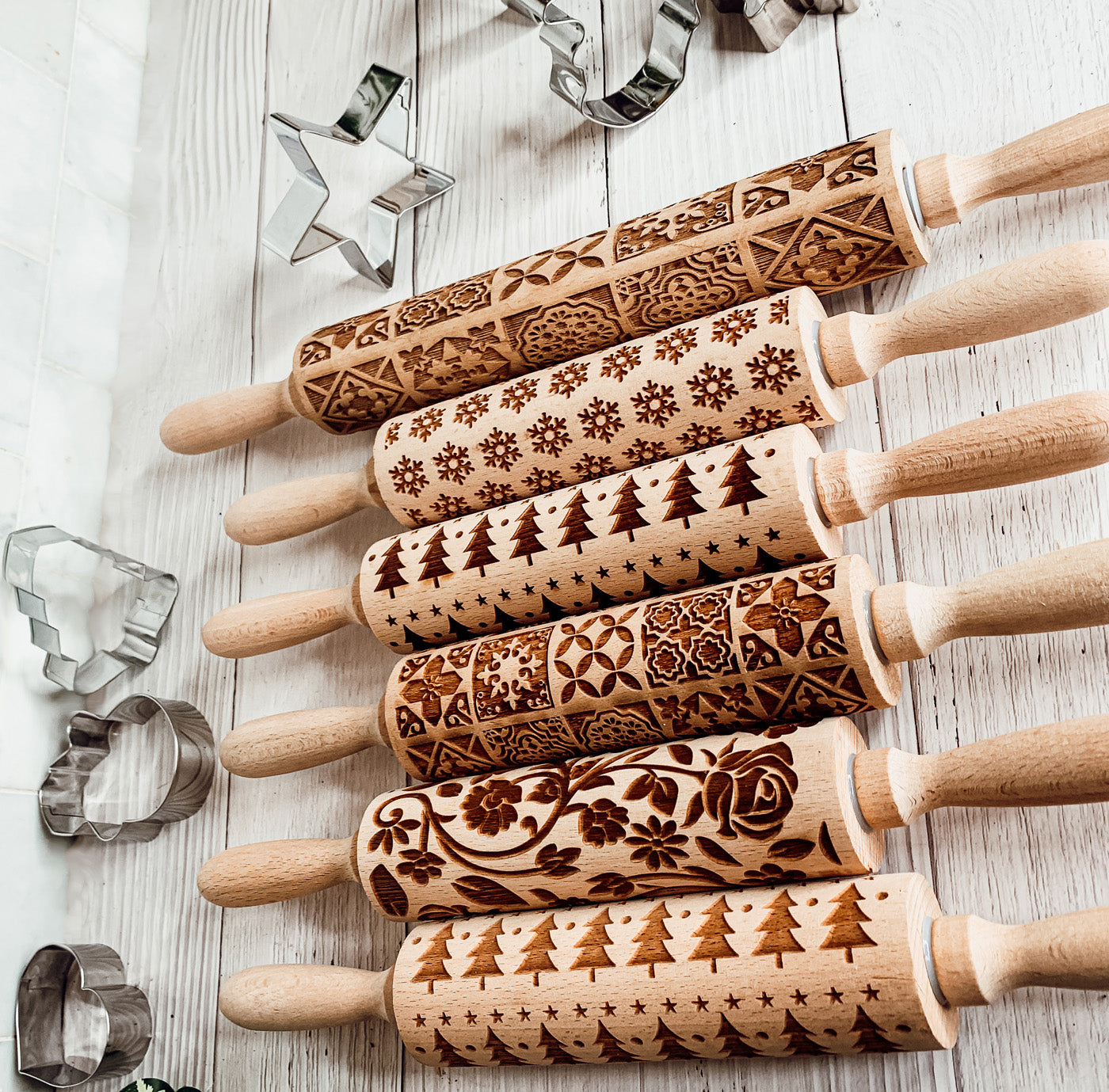 Colorful Easter and Spring rolling pins with floral and bunny designs, accompanied by two metal cookie cutters, perfect for festive baking.