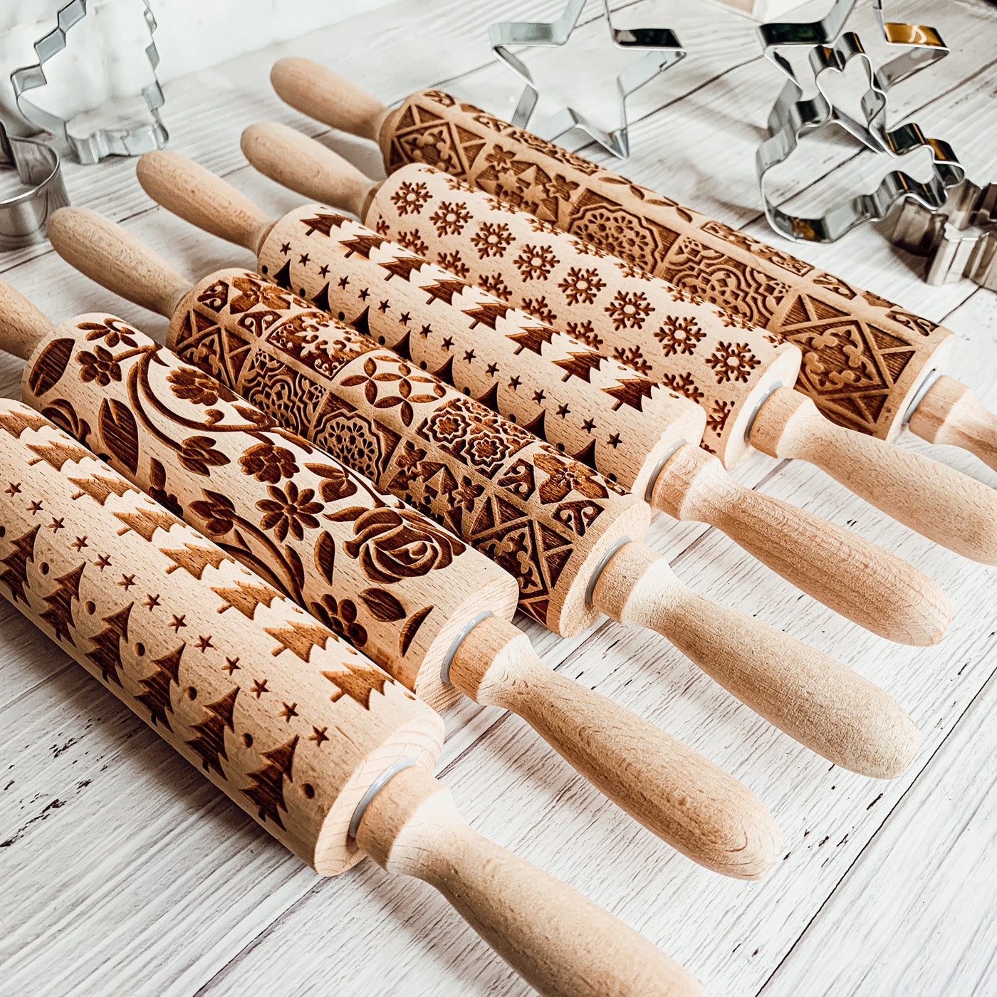 Colorful Easter and Spring rolling pins with floral and bunny designs, accompanied by two metal cookie cutters, perfect for festive baking.