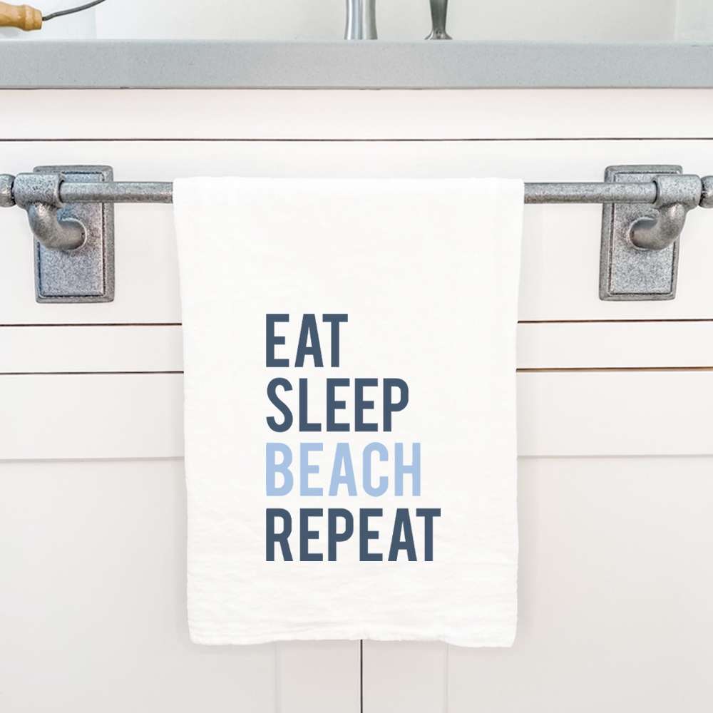 A vibrant cotton tea towel featuring the phrase 'Eat Sleep Beach Repeat', showcasing a beach-themed design with hemmed edges.