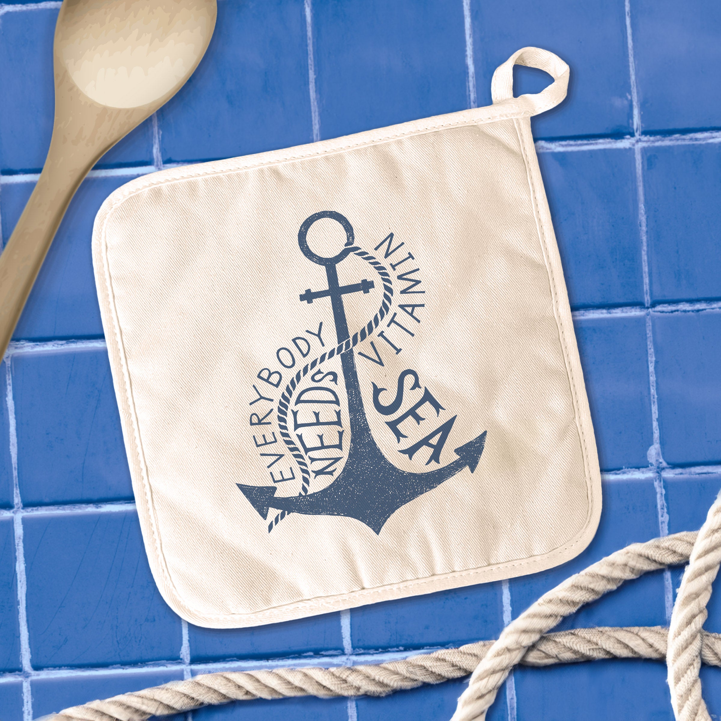 A vibrant cotton pot holder featuring the design 'Everybody Needs Vitamin Sea', showcasing its square shape and hanging loop.