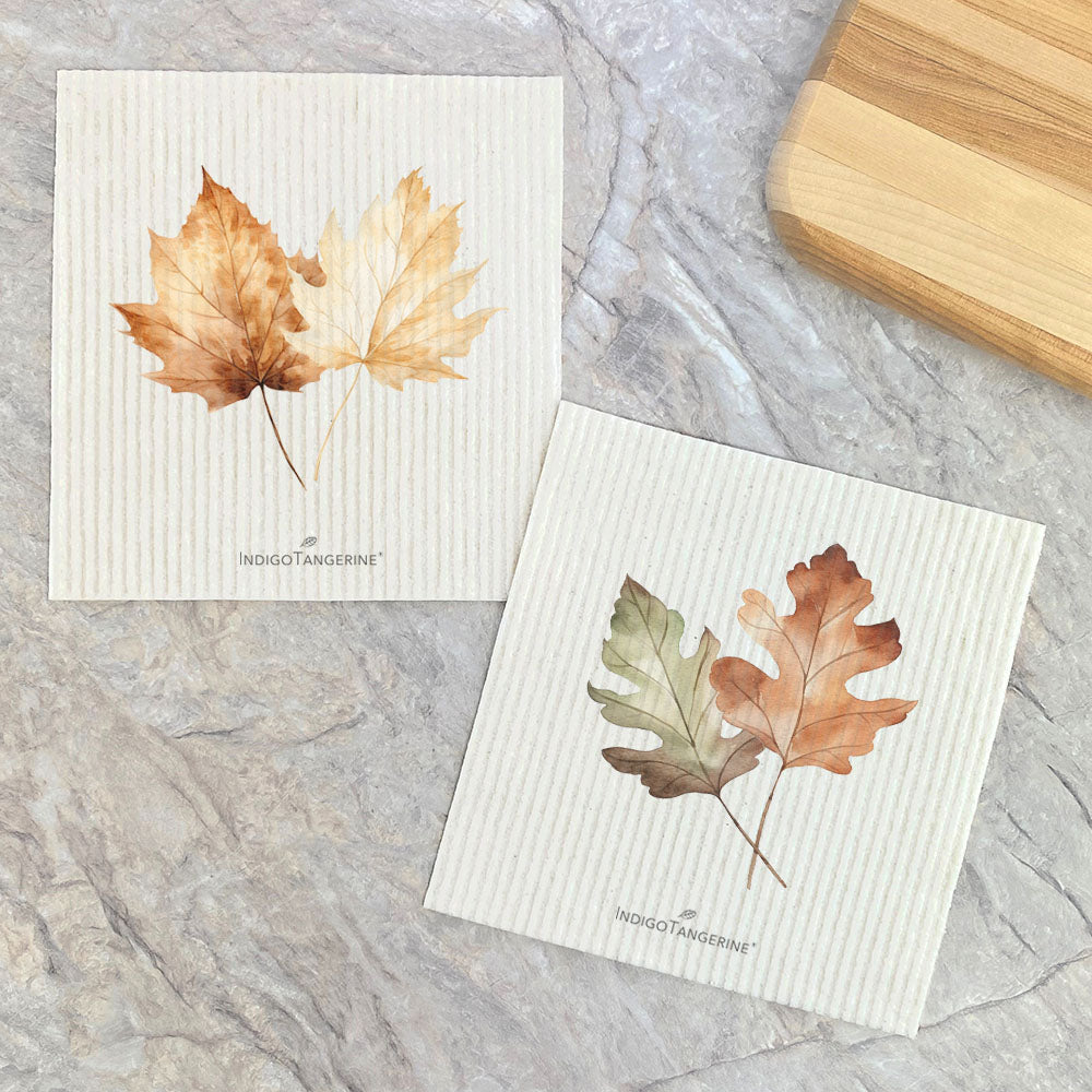 Two eco-friendly Swedish dish cloths featuring fall leaves design, made from plant-based fibers.