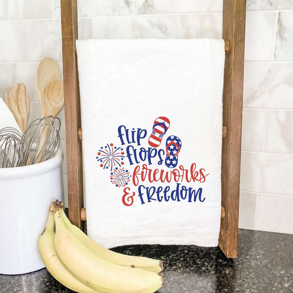 Colorful cotton tea towel featuring flip flops and fireworks design, perfect for kitchen use.