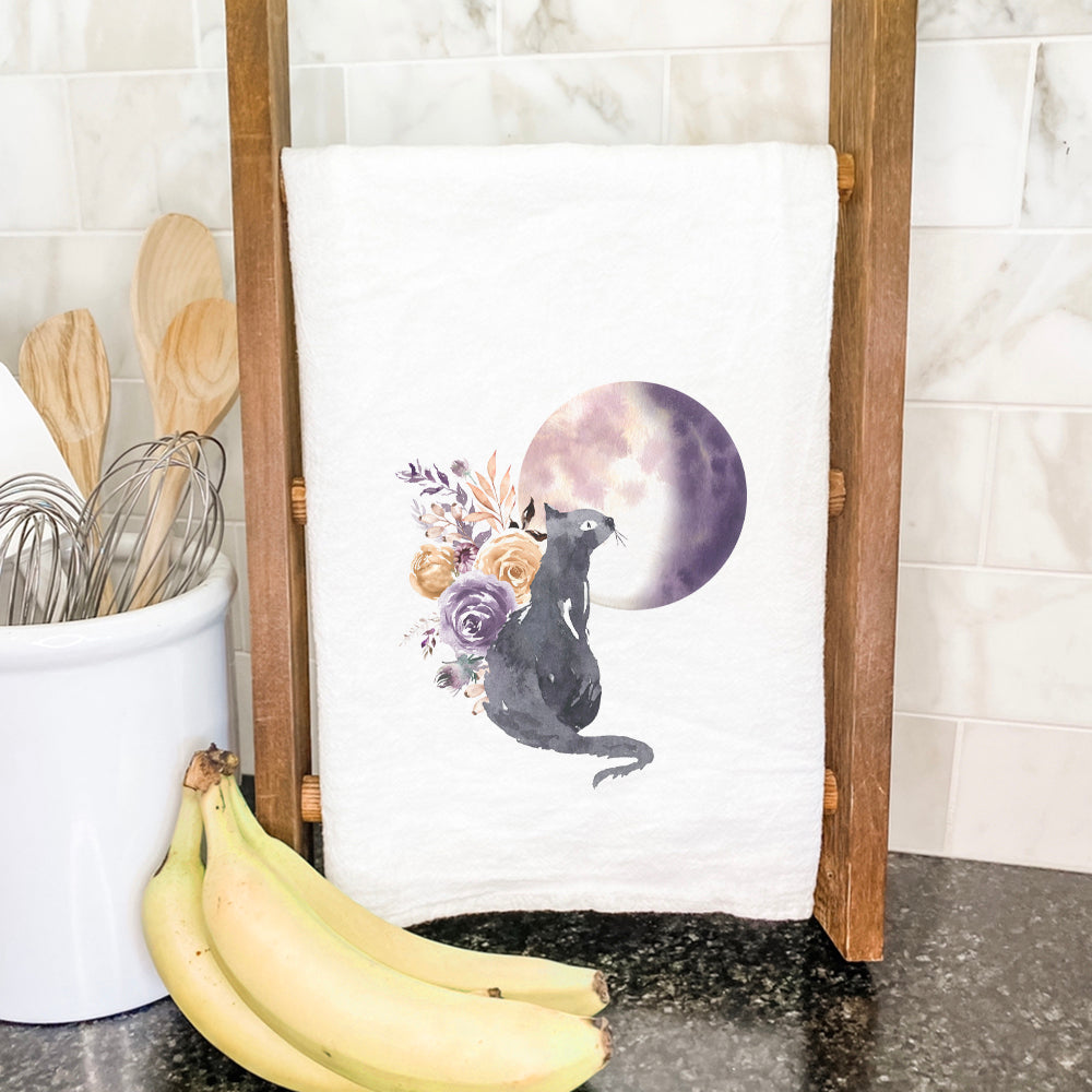 A vibrant cotton tea towel featuring a floral black cat design, perfect for kitchen use.