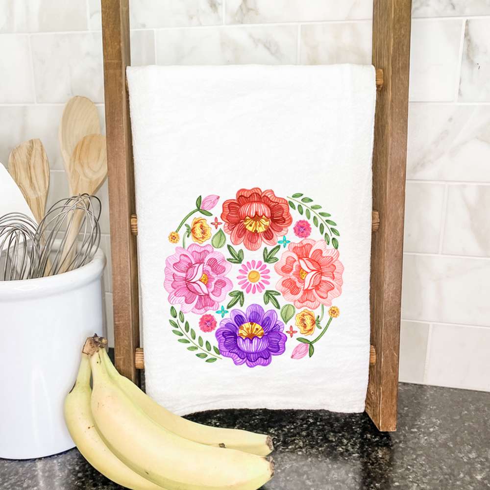 Floral Circulo Cotton Tea Towel featuring vibrant floral design, hemmed edges, and 100% absorbent cotton material.