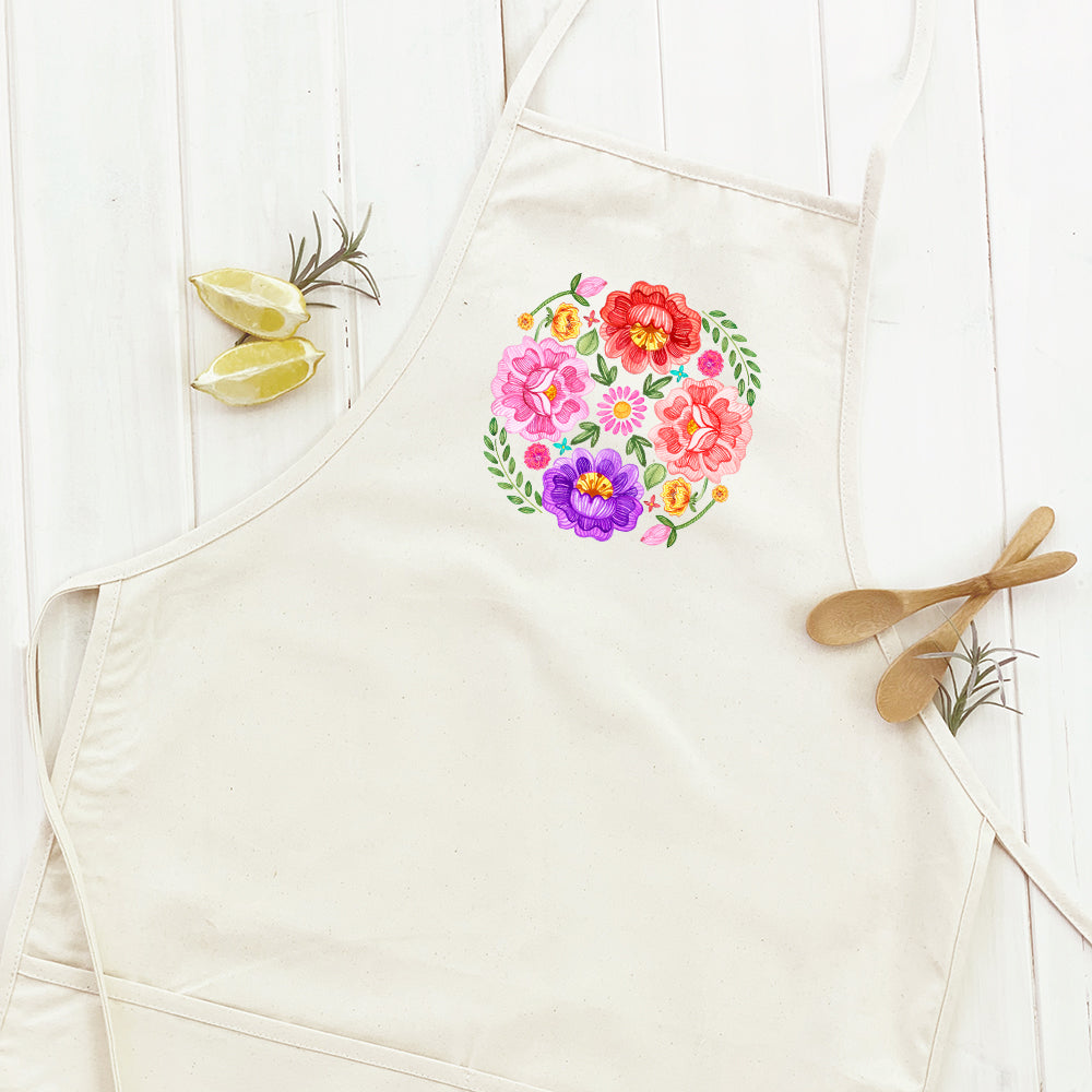 Floral Circulo Women's Apron featuring a vibrant floral design, adjustable neck strap, and divided front pocket, made from durable cotton canvas.