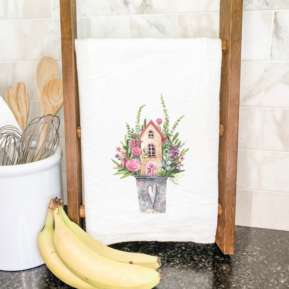 Floral Pail Fairy House cotton tea towel featuring vibrant floral design, hemmed edges, and 27-inch square size.