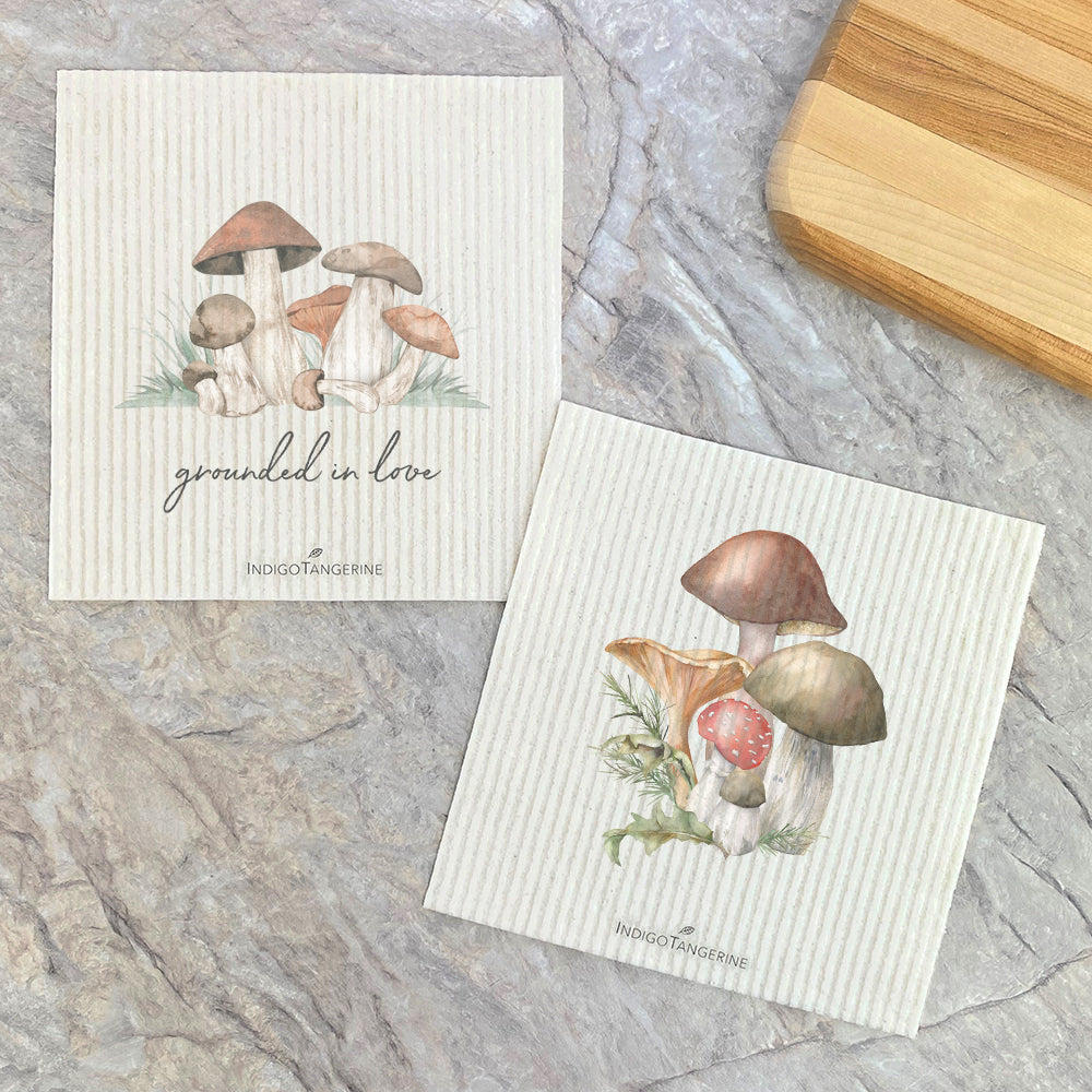 Two Swedish dish cloths featuring forest mushroom designs, eco-friendly and compostable, made from plant-based fibers.