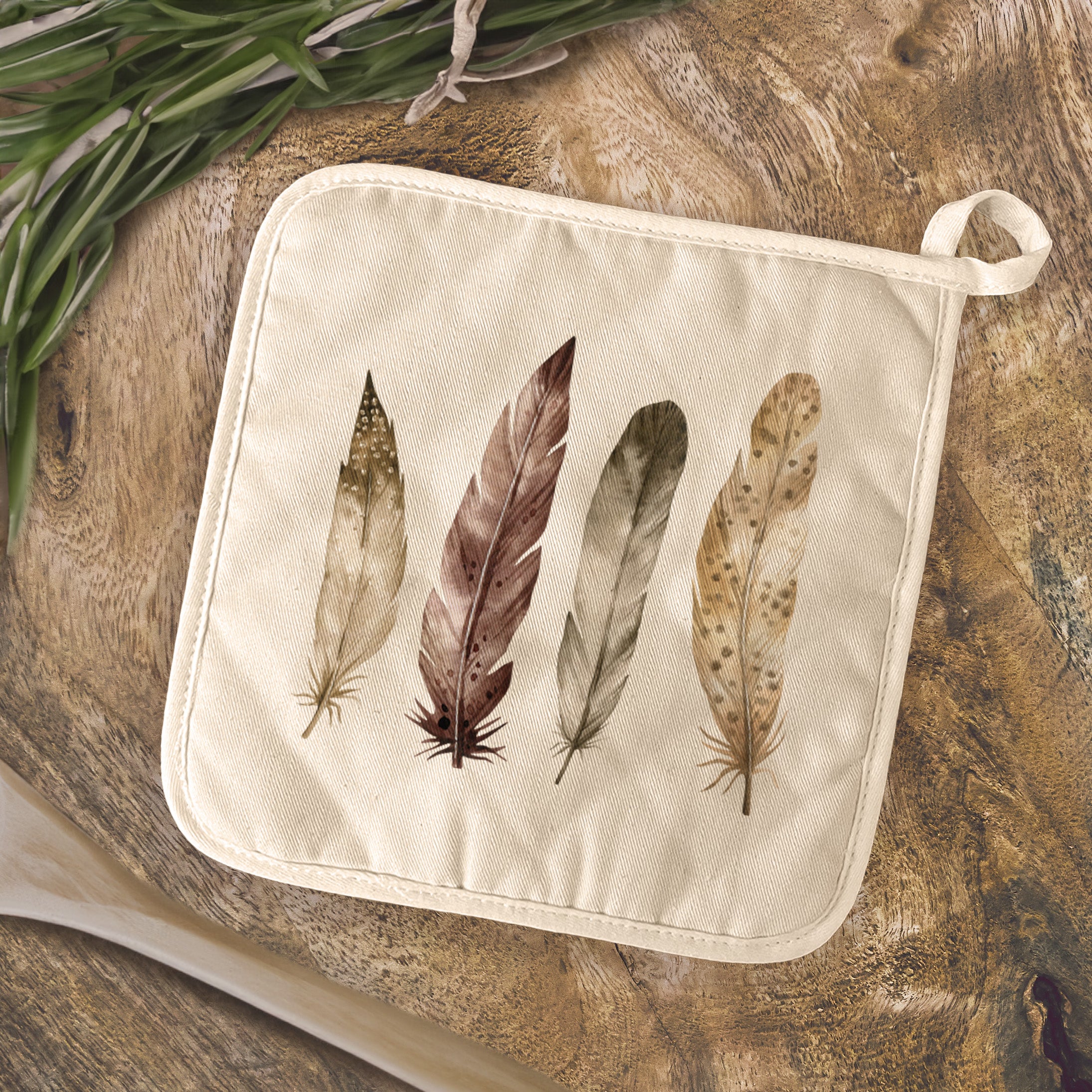 Four Feathers Cotton Pot Holder featuring vibrant designs and a convenient hanging loop, made from natural cotton and terry cloth.