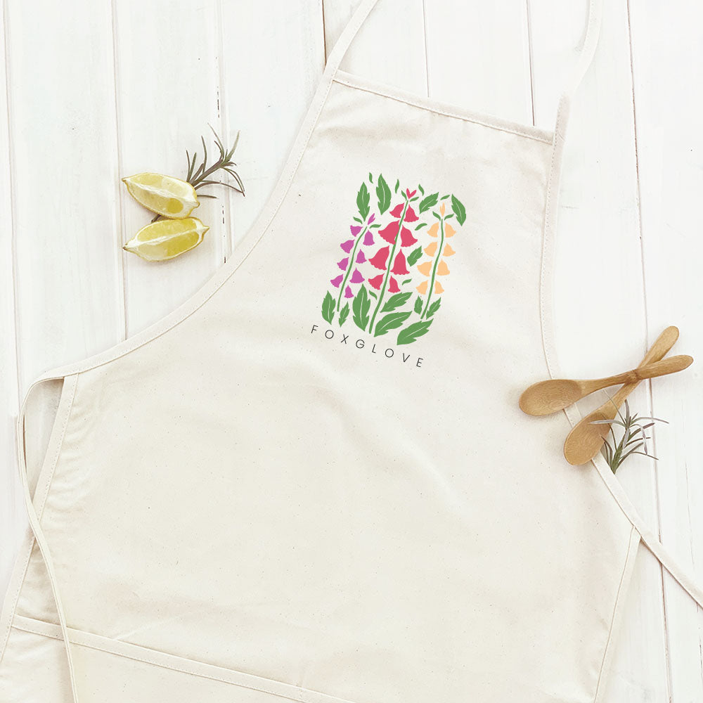 Foxglove Women's Apron featuring elegant design, cotton canvas fabric, and divided front pocket, perfect for gardening and cooking.