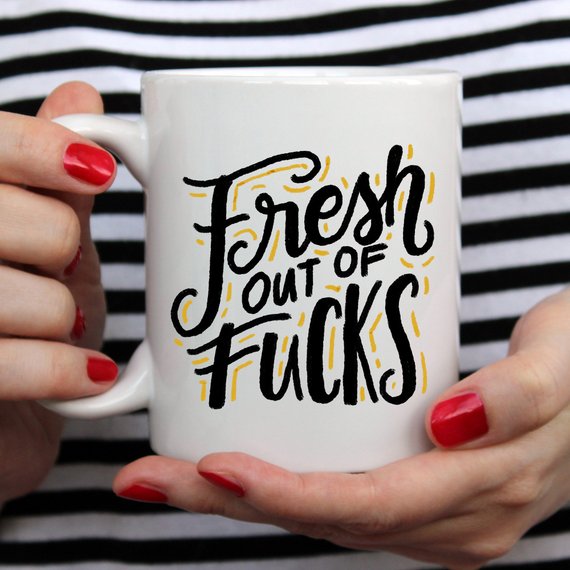 A humorous coffee mug with the phrase 'Fresh Out Of F*cks' printed on it, showcasing a fun design perfect for gag gifts.