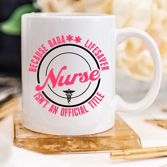 A high-quality white coffee mug featuring the text 'Nurse - Because Bada** Lifesaver Isn't An Official Title' in bold, vivid letters, perfect for nurses.