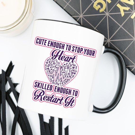 A humorous coffee mug for nurses featuring the phrase 'Cute Enough To Stop Your Heart, Skilled Enough To Restart It' with a vibrant design.