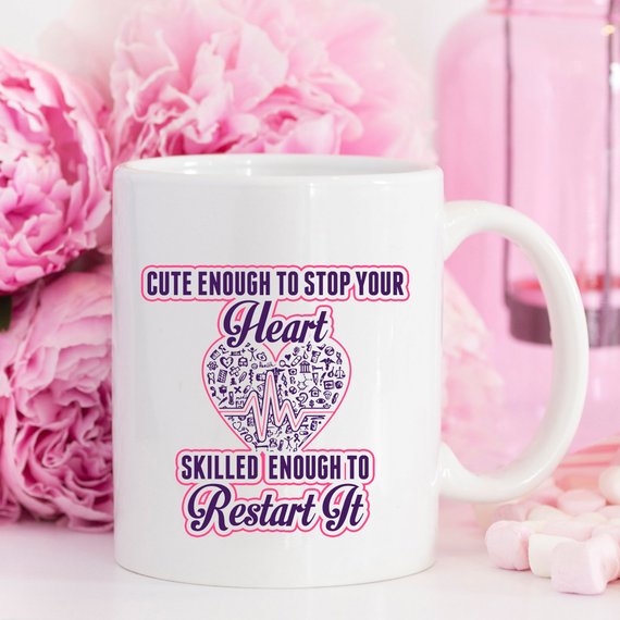 A humorous coffee mug for nurses featuring the phrase 'Cute Enough To Stop Your Heart, Skilled Enough To Restart It' with a vibrant design.