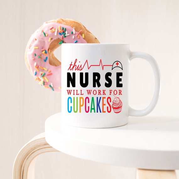 A high-quality ceramic coffee mug featuring the humorous text 'This Nurse Will Work For Cupcakes', perfect for nurses and coffee lovers.